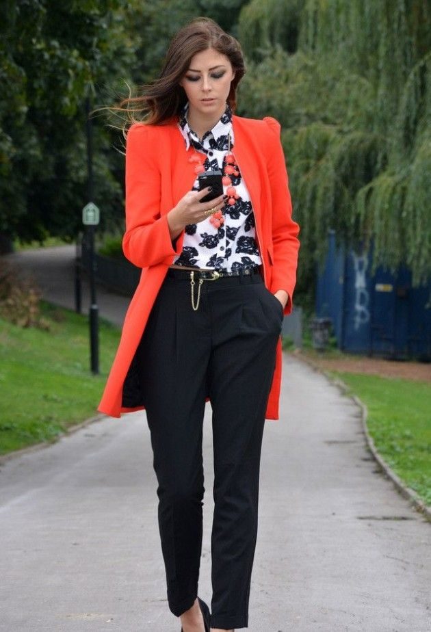 birght-orange-coat-and-necklace-in-black-and-white-outfit
